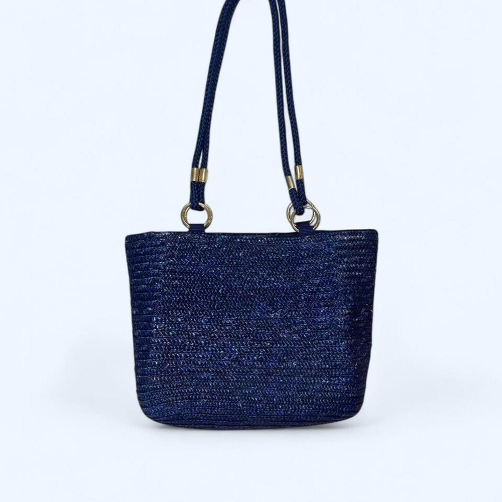 Navy blue woven straw tote bag with gold hardware and cotton lining
